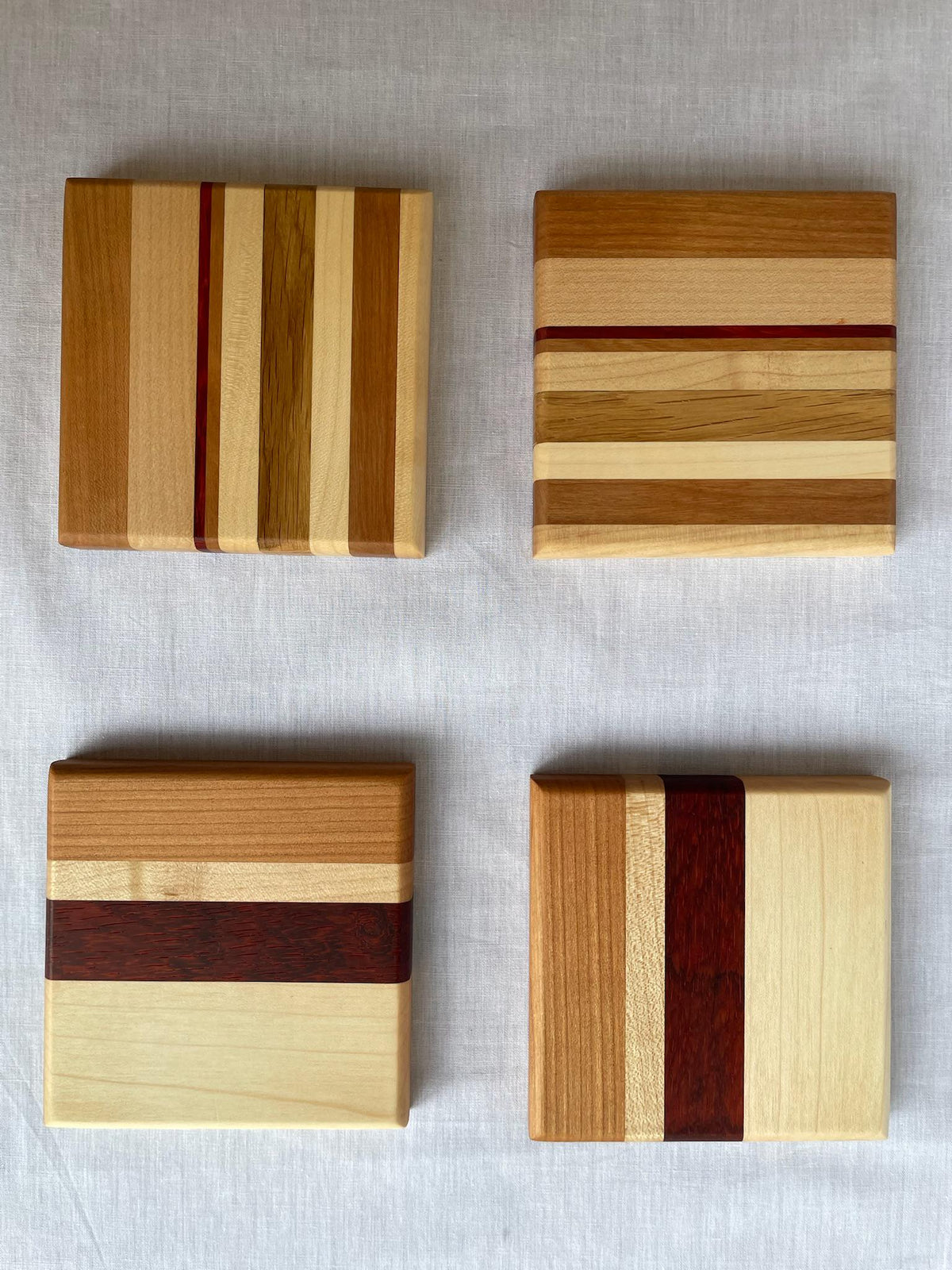 Wooden Coaster Set of 4, Handmade Six-Wood Drink Coasters in Ash, Cherry, Maple, Oak & Padauk, Housewarming Gift, Made in the Netherlands